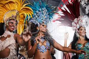 Stealing the show with their dazzling performances. Shot of samba dancers performing in a carnival.