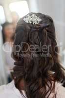 Add elegance to your wedding day with a beautiful hairpiece. Rearview shot of a womans hairdo on her wedding day.