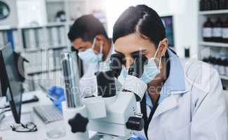 Chemistry is like cooking for scientists. Shot of two young researchers working in a laboratory.