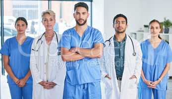 Dont judge each day by the harvest you reap. Shot of a group of doctors standing against a city background.