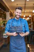 I can now easily track my supply deliveries online. Portrait of a business owner using a digital tablet in his store.