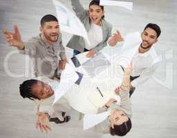 The value of achievement lies in the achieving. Aerial shot of a diverse group of businesspeople throwing paperwork in the air in celebration while in the office.