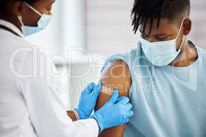 There that will kick in soon. Shot of a doctor applying a plaster to her patients arm.
