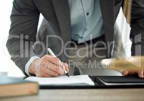 This will set me up for life. Shot of a lawyer signing a contract in his office.