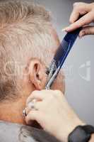 Getting a fresh new cut. Shot of a man getting a haircut in a salon.