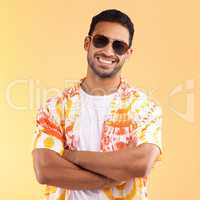 Its vacation time. Shot of a young man wearing glasses and a tie dye shirt while standing against a yellow background.