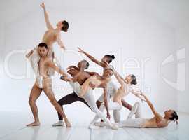 Through dance, we can present a solid story. Shot of a group of ballet dancers practicing a routine in a dance studio.