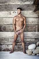 How could masculinity get more masculine. Full length shot of a handsome young man holding a football while posing nude.