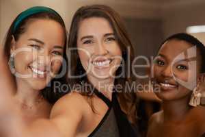 This will be a night to remember. Shot of a young group of friends standing together and posing for a selfie during a New Years dinner party.