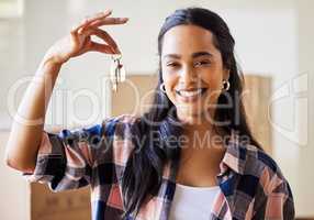 New beginnings means refreshed hope. Shot of a young woman showing the keys to her new home.