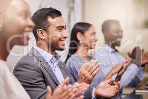 Celebrate the success of your colleagues. Shot of a team of work colleagues giving applause during a business meeting.