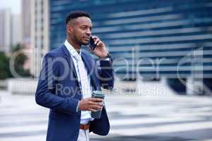 If you want to achieve greatness stop asking for permission. Shot of a young businessman walking and using a phone in the city.