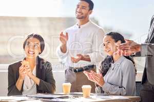 Inspired and excited to continue succeeding together. Shot of a group of businesspeople applauding during a meeting in an office.