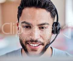 Of course we can upgrade you. Shot of a handsome young man working in a call center.