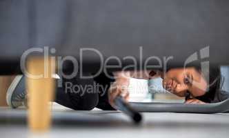 For every minute spent on cleaning, an hour is earned. Shot of a young woman vacuuming under the couch at home.