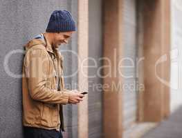 Hooking up with my buddy later on. Cropped shot of a fashionable man using his mobile phone in the city.