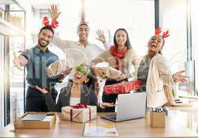 Sharing the Christmas spirit. Shot of a group of businesspeople celebrating during a Christmas party at work.