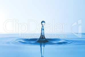 No drop too big, no drop too small. Abstract studio shot of a water droplet falling into a puddle of water.