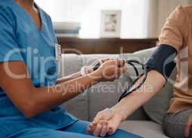 Take the test, live your best. Shot of a doctor examining a senior woman with a blood pressure gauge at home.