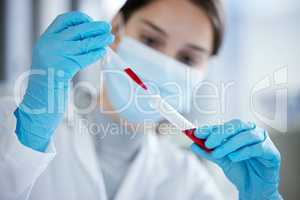Doing multiple tests to confirm the results. Closeup shot of a young woman using a dropper and test tube while working with samples in a lab.