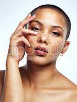 I wouldnt change a thing about myself. Studio shot of a beautiful young woman posing with glitter freckles on her face.