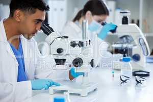 What will we discover today. Shot of two scientists using microscopes in a lab.