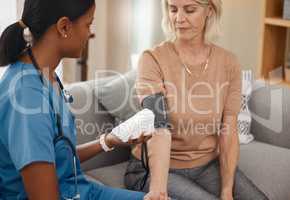 Blood pressure, detect and protect. Shot of a doctor examining a senior woman with a blood pressure gauge at home.