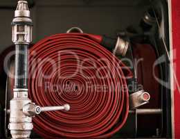 Behind the scenes at the fire station. Cropped shot of a coiled fire hose.