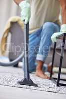 Lets clean this carpet right. Shot of an unrecognizable person vacuuming at home.