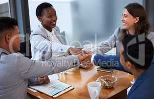 None of us is as smart as all of us. Shot of a group of colleagues having a meeting and breakfast in a modern office.