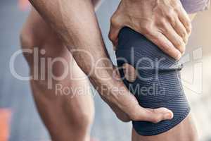 Doing a lot of high-stress exercises can hurt your knee. Closeup shot of an unrecognisable man holding his knee in pain while exercising in a gym.