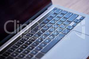 Staying on top of business changes. Shot of a laptop on a desk in an empty office during the day.