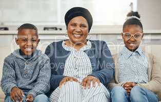 The perfect visit. Shot of a grandmother bonding with her grandkids on a sofa at home.