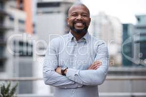 Confidence allows you to venture further than ever. Portrait of a confident mature businessman standing with his arms crossed on a balcony outside an office.