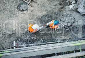 We dont just built properties, we build relationships. Shot of two builders shaking hands at a construction site.