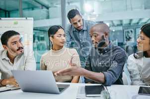 I think we have some changes to make. Shot of a group of businesspeople using a laptop during a meeting.