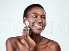 It just melts the makeup away. Studio shot of a beautiful young woman wiping her face with cotton against a grey background.