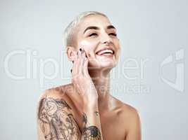 Moisturizing is rule number one. Studio shot of a beautiful young woman posing against a grey background.