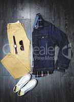 Accessories to match the outfit. High angle shot of a casual outfit on a wooden outfit.