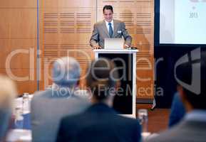 Presenting with ease. A confident businessman giving a presentation at a press conference.