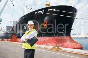 I wouldnt trade my work for anything.. A happy foreman standing with his arms crossed in front of a ship..