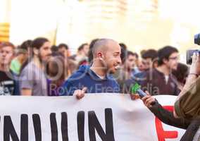 We need to be heard. Shot of a protestor being interviewed at a rally.