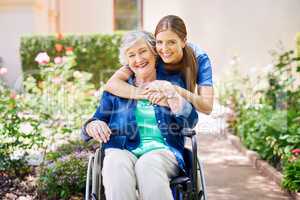 Ive got her back. Shot of a resident and a nurse outside in the retirement home garden.