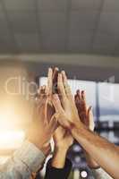 Heres to a job well done. Shot of a group of colleagues giving each other a high five.