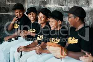 Baseball is a great way to keep kids active and socially engaged. Cropped shot of a group of young baseball players sitting together on the bench during a game.