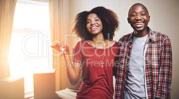 Glad to be calling this place our home sweet home. Shot of a young couple moving into their new home.