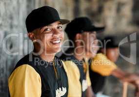 Im happiest when I play baseball. Portrait of a young baseball player sitting with his teammates.