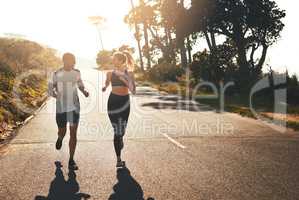 Getting the blood flowing with a workout buddy. Shot of a fit young couple going for a run outdoors.