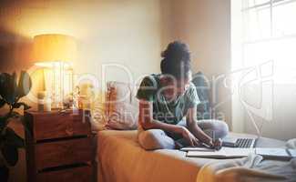 Shes a diligent student. Full length shot of a young female student studying at home.