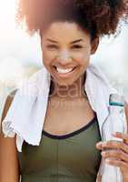 Staying hydrated is essential for your health. Cropped shot of a young woman enjoying a bottle of water while out for a run.